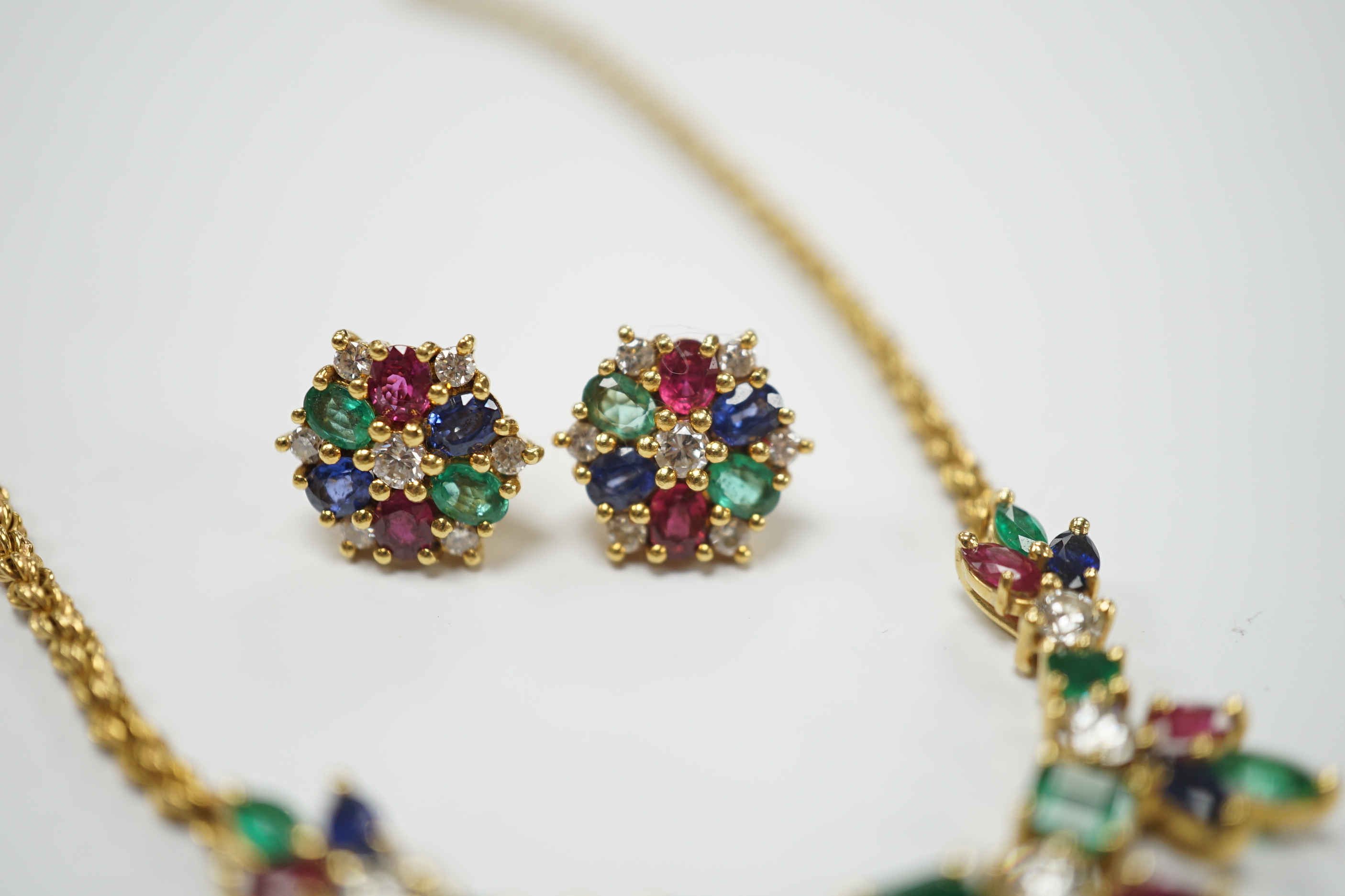 A 1960's? yellow metal, ruby, sapphire, emerald and diamond cluster set 'tutti fruiti' necklace, 44cm and pair of matching ear studs, the butterflies stamped 750